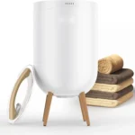 Heated towel bucket with Bluetooth speaker and ambient light placed in a modern bathroom